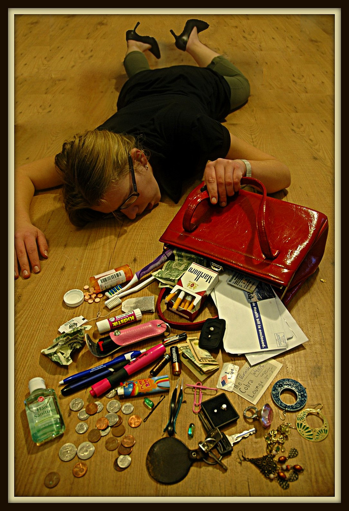 "photograph of girl collapsed on floor with the contents of her purse spilled out"