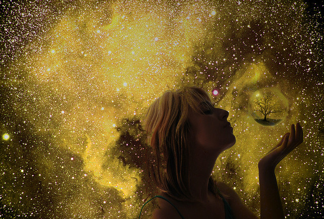 "photographic homage to The Fountain with cosmic woman surrounded by stars blowing a bubble into space"