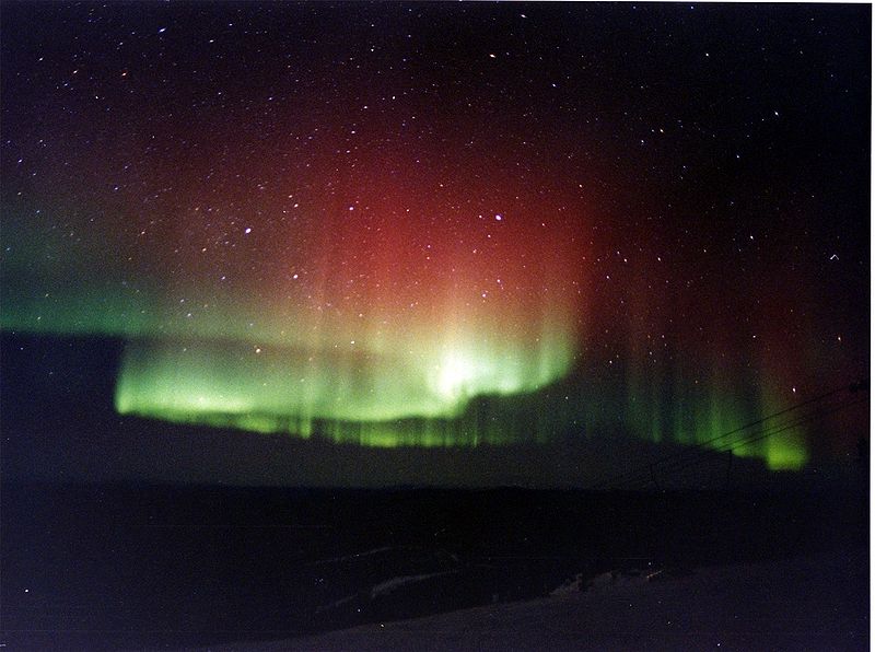 "photograph of the aurora borealis in red and green"