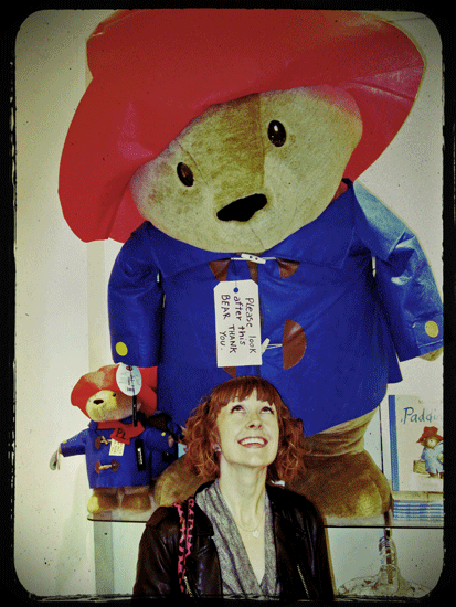"image of alli woods frederick with giant stuffed paddington bear at sax fifth avenue in dallas"